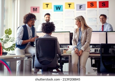 A group of employees chatting in a pleasant atmosphere in the office. Employees, job, office - Shutterstock ID 2139208845