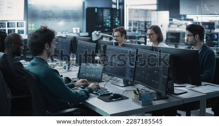 Group of Empowered Multicultural Men and Women Working in a Research Center, Using Computers to Run Advanced Software, Develop Artificial Intelligence Interface and Cyber Security Protocols