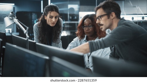 Group of Empowered Multicultural Specialists Working in a Research Center, Using Computer to Collaborate on Advanced Software, Develop Artificial Intelligence Interface and Cloud-Based Blockchain - Powered by Shutterstock