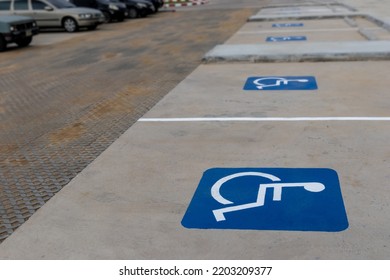 Group Of Empty Disable Person Parking Sign Or Wheelchair Symbol In The Parks With No People And Blurred Outdoors Background. Selective Focus And Copy Space. 