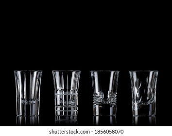 Group Of Empty Shot Glasses In A Black Background.