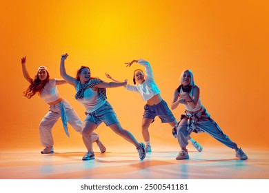 Group of energetic dancers in casual retro outfits performing contemporary dance in vibrant neon light against gradient studio background. Concept of music, fashion and art, movement, sport and hobby. - Powered by Shutterstock