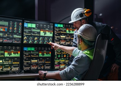 Group of engenners following production line using computer screens with Industry 4.0. Couple of factory operators controll assembly line using screens with human-machine interface - Powered by Shutterstock