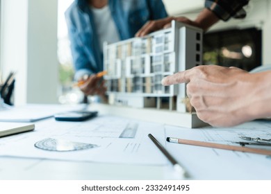 Group of engineer is discussion and brainstorming about condominium model of construction project. - Powered by Shutterstock