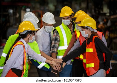 Group Of Engineer Manager And Factory Workers Team Standing Against Production Line. Teamwork Concept.