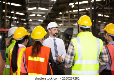 Group Of Engineer Manager And Factory Workers Team Standing Against Production Line. Teamwork Concept.