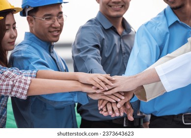 Group of Engineer United stack hands or join hand teamwork together with Spirit diversity solidarity team Partner. Joins hands together teamwork meetings empower.