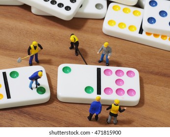 Group of engineer workers are making dominos