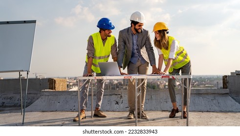 Group of engineers, architects, business partners at construction site working together - Shutterstock ID 2232833943