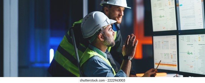 Group of engineers control process of production uses computer with modern SCADA system. Team of workers operator follow of industry process on factory