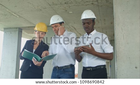 Group of engineers and experts discuss about construction site