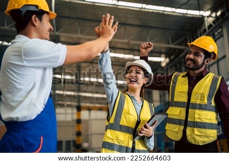 Group of engineers, industrial workers congratulation each other with high five gesture after success of meeting or finishing project in the factory. 
