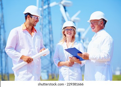 Group Of Engineers On Wind Power Station