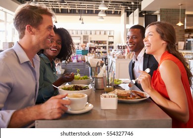 Group Enjoying Business Lunch In Delicatessen