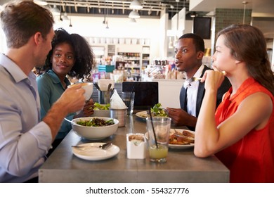 Group Enjoying Business Lunch In Delicatessen