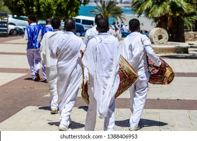 Group Ethiopian Mens Dressed In Traditional White Clothes Carrying Kebero Drums