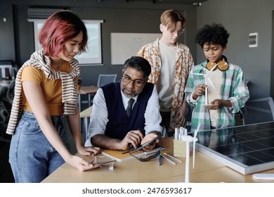 Group of ethnically diverse students learning about renewable energy technologies during lesson at school - Powered by Shutterstock