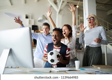 Group of excited people shouting cheerfully after goal while watching online broadcast of world championship - Powered by Shutterstock