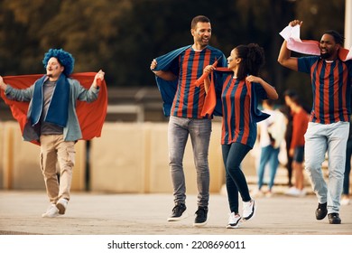 Group Of Excited Soccer Fans Celebrating On The Street.