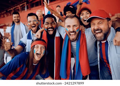 Group excited of sports fans shouting from stadium stands and looking at camera. - Powered by Shutterstock