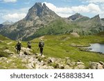 Group of experienced hikers hiking in beautiful mountains in Pyrenees (Lacs d