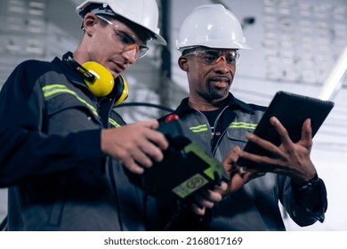 Group Of Factory Job Workers Using Adept Machine Equipment In A Workshop . Industry Manufacturing And Engineering Technology Concept .