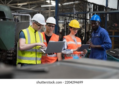 Group Of Factory Worker Working With Computer Laptop In Factory. Male And Female Worker Discussing And Training About Work At Factory.