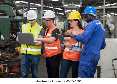 Group Of Factory Worker Working With Computer Laptop In Factory. Male And Female Worker Discussing And Training About Work At Factory.