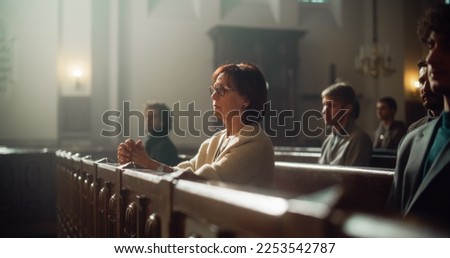 Group Of Faithful Parishioners In Grand Old Church Listening to Sermon. Devout Christian Lady with Folded Hands is Praying. People Seek Moral Guidance From the Religios Fait in The Sacred Place