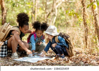 Group Family Children Checking Map For Explore And Find Directions In The Camping Jungle Nature And Adventure. Tourism Kids Travel For Destination And Leisure Trips For Education And Relax In Nature