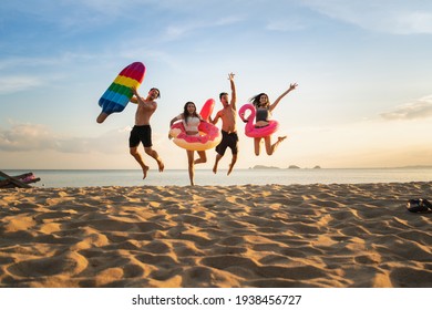 Group Of Family And Friends  Jumping On The Beach. Lifestyle People Vacation Holiday On Beach. Summer Group Of Friends At Beach.