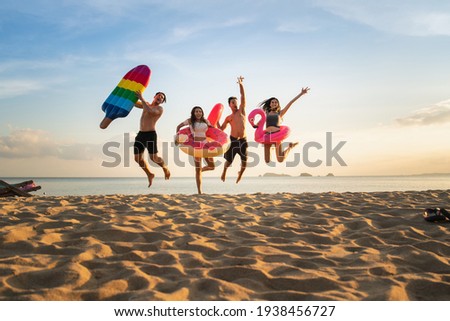 Group of family and friends  jumping on the beach. lifestyle people vacation holiday on beach. Summer group of friends at beach.