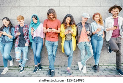 Group of fashion friends watching on their smart mobile phones - Millennial generation z addicted to new technology trends - Concept of people, tech, social media, friendship and youth lifestyle - Shutterstock ID 1254124996