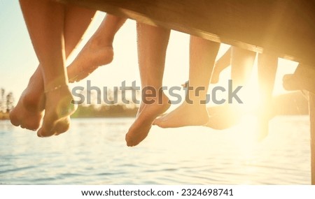 Group, feet on water and friends together at ocean, pier or outdoor in summer, vacation or freedom in holiday break. Teen, foot and children to relax at the lake, harbor or river on the weekend