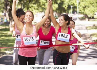 Group Of Female Athletes Completing Charity Marathon Race - Powered by Shutterstock