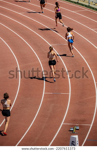 group female\
athletes start running 400\
meters