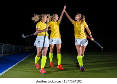 Group of female field hockey players celebrate the victory - Powered by Shutterstock