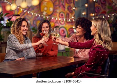  Group Of Female Friends Celebrating Making Toast Enjoying Party Night Out In Bar