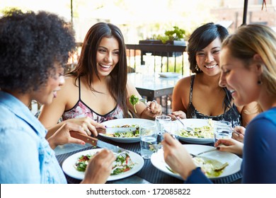 Group Of Female Friends Enjoying Meal At Outdoor Restaurant