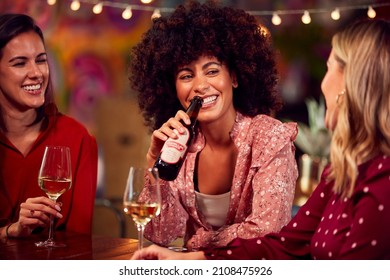  Group Of Female Friends Enjoying Party Night Out In Bar Drinking Beer And Wine