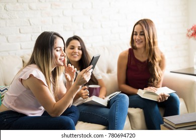 Group Of Female Friends Having Some Fun While Reading In Their Book Club Reunion