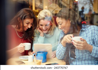 Group Of Female Friends In CafÃ?Â¢?? Using Digital Devices