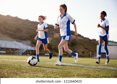 Group Of Female High School Students Playing In Soccer Team
