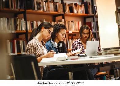 Group of female students study in the school library.Learning and preparing for university exam.Education concept. - Shutterstock ID 1010404012
