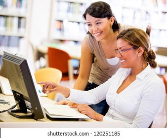 Group Of Female Students Working Together On A Computer