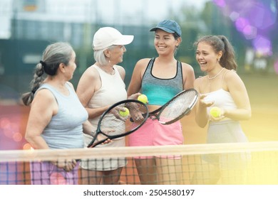 Group of female tennis players talking while playing on court - Powered by Shutterstock