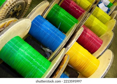 Group of fiber optic cable reels with intertwined optical fibers - Shutterstock ID 2213595997