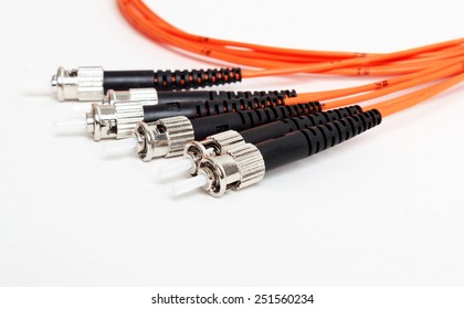 group of fiber optic ST connectors on orange patchcord 