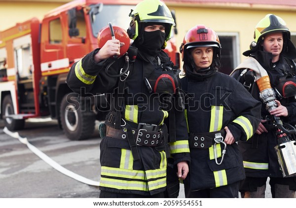 Group of firefighters in protective uniform that\
is on station.