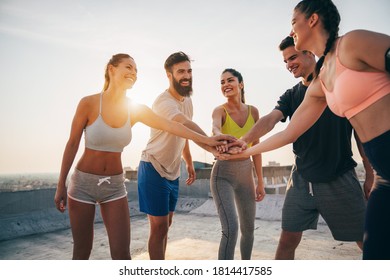 Group of fit healthy friends, people exercising together outdoor - Powered by Shutterstock